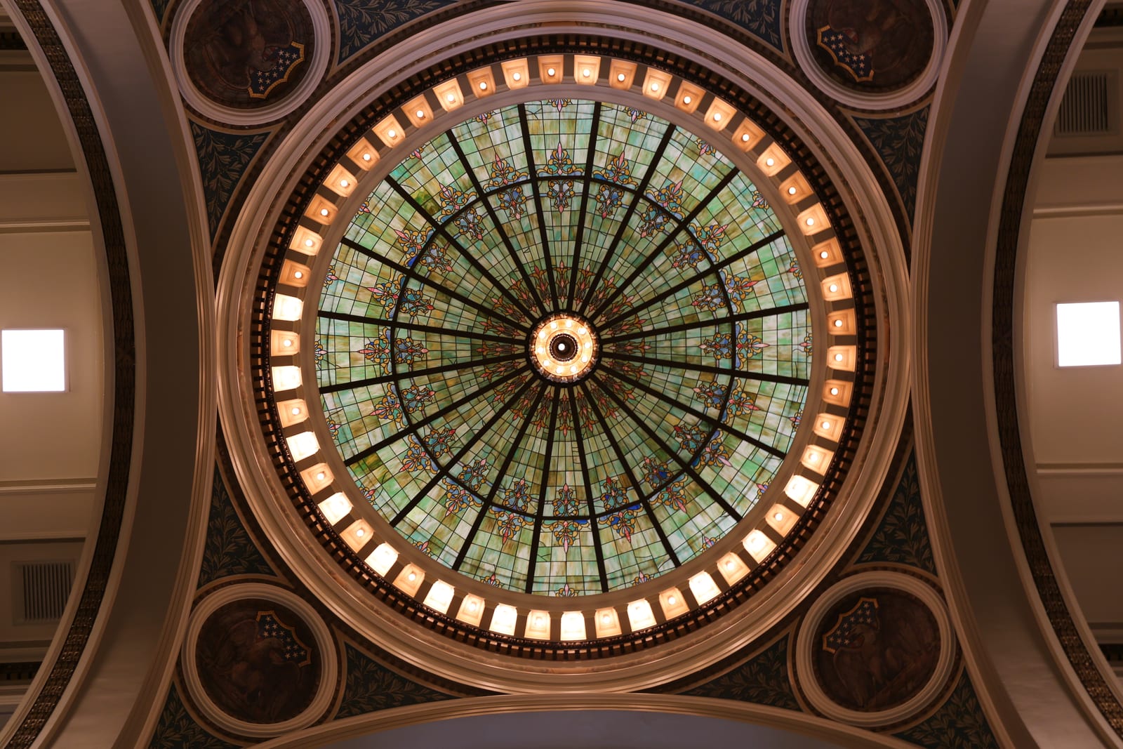 Intricate stained glass dome with vibrant patterns viewed from below